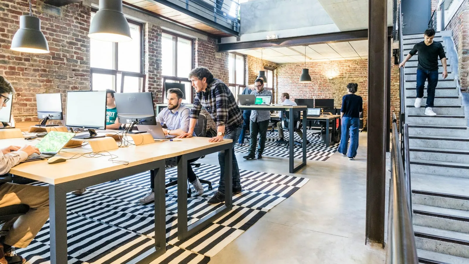 A senior engineer working alongside a client team in their office